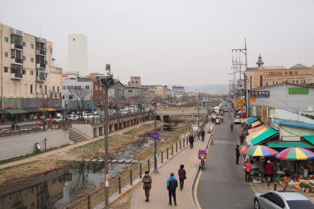 This is the center of Hwaseong Fortress, there are walls and gates surrounding the town's center...