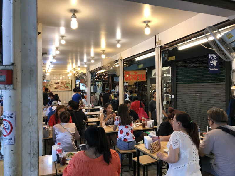 People eating inside Chatuchak Weekend Market